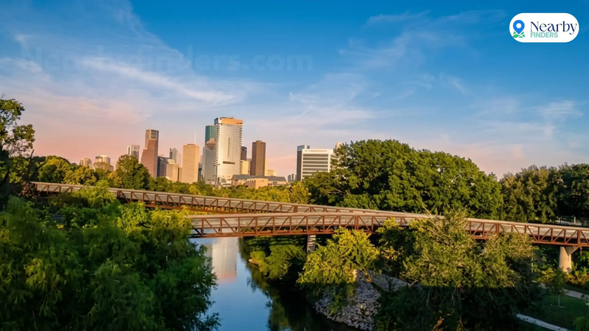 Free things to do in Houston: Breathtaking twilight view of the downtown Houston skyline and illuminated pedestrian bridge over Buffalo Bayou Park