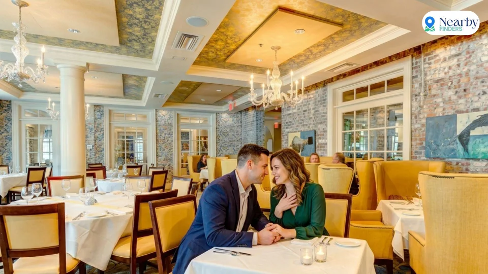 Romantic restaurants for couples in Houston: An elegant couple holding hands at a candlelit table inside the historic Southern-style dining room at Brennan's